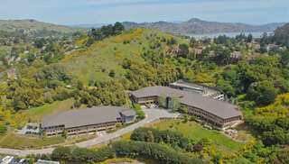An aerial view of the Belvedere Place office complex surrounded by green rolling hills.